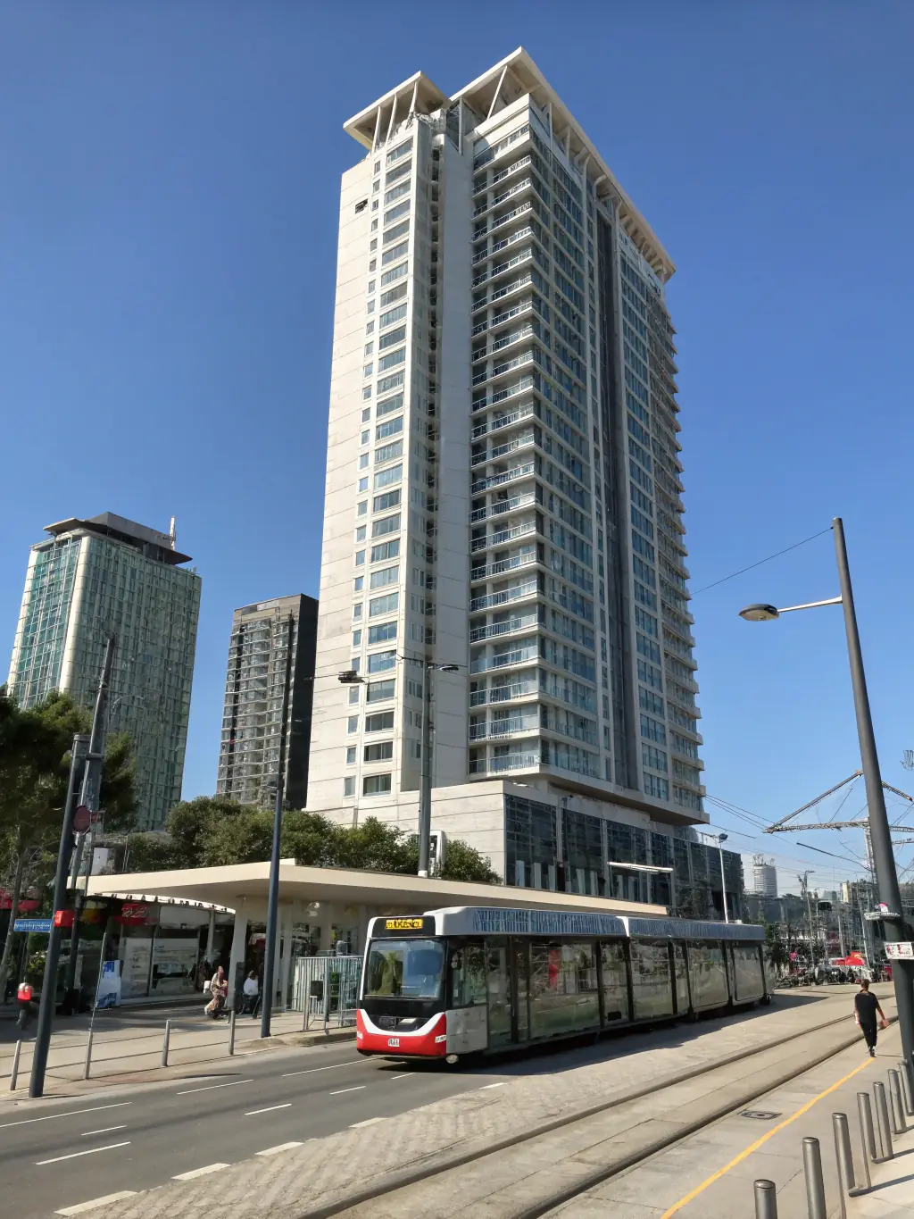 A high-rise condominium building with visible balconies, symbolizing the condominium drain cleaning services provided by SENIOR PLUMBERS™.
